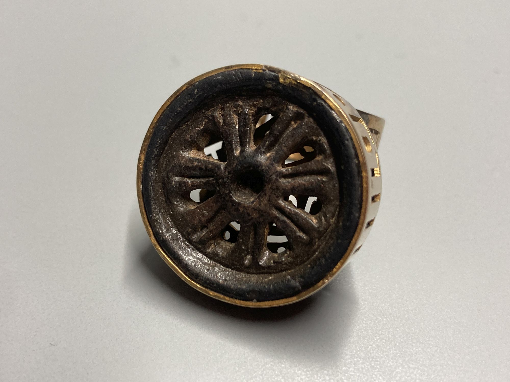 An unusual Chinese pierced gilt metal and base metal inset ring, size P, and matching pendant, overall 53mm.